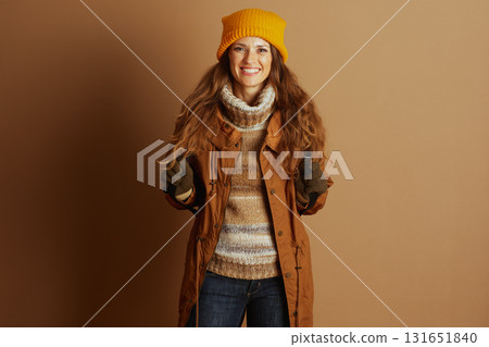 Joyful Hiker in Winter Attire with Ski Poles Joyful Hiker in Winter Attire with Ski Poles 131651840