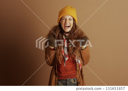Ecstatic Woman Yells in Triumph, Winter Outfit 131651857