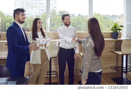 Positive Business People Engaging in Handshake at the Office Positive Business People Engaging in Handshake at the Office 131652055