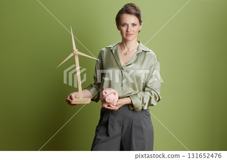 Investing in Green: Woman and Wind Turbine Model 131652476