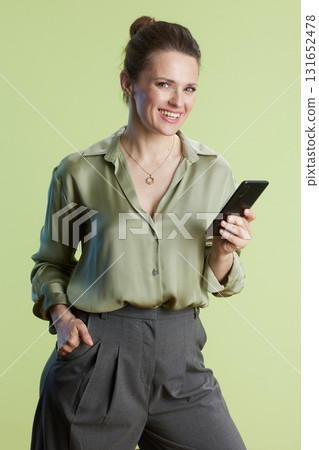 Smiling professional with smartphone in hand 131652478