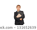 A woman in a business suit holding documents 131652639