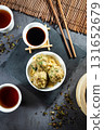 Stylish black stone textured background setup, top down view capturing traditional Hong Kong dim sum beef balls at a local teahouse 131652679