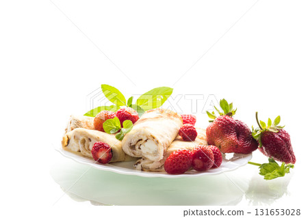 Plate with pancakes and fresh strawberries on white 131653028