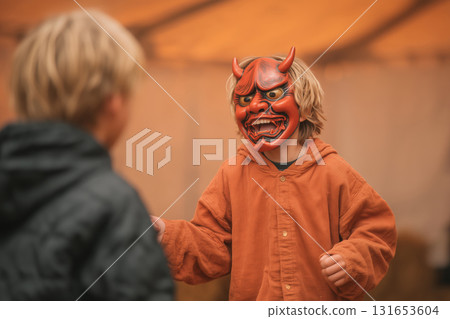 Child joyfully plays while throwing beans at parent in a fun setting 131653604
