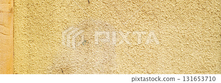 Old painted yellow cement wall. Rough building surface. Colorful grunge background Old painted yellow cement wall. Rough building surface. Colorful grunge background 131653710