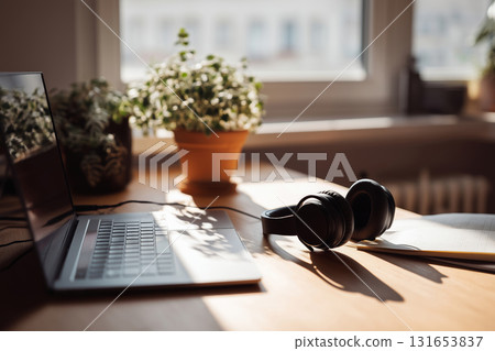 Inviting home office setup with notebook and greenery during the day Inviting home office setup with notebook and greenery during the day 131653837