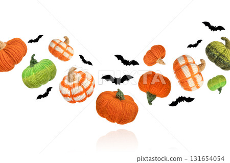 Knitted orange and green pumpkins with black bats on white background, autumn composition. Halloween concept. Knitted orange and green pumpkins with black bats on white background, autumn composition. Halloween concept. 131654054