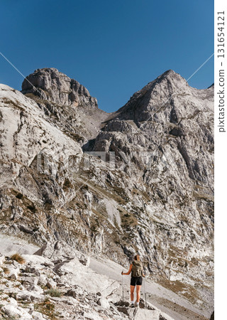 Woman Hiking Alone in Alpine Mountain Landscape 131654121