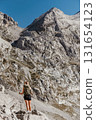 Woman Hiking Alone in Alpine Mountain Landscape 131654123