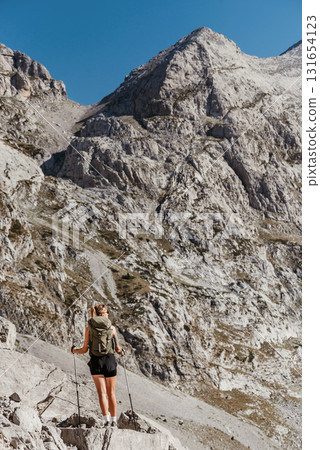 Woman Hiking Alone in Alpine Mountain Landscape 131654123