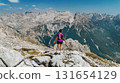 Woman Standing on Mountain Summit in Albanian Alps 131654129