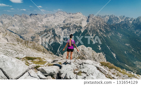 Woman Standing on Mountain Summit in Albanian Alps 131654129