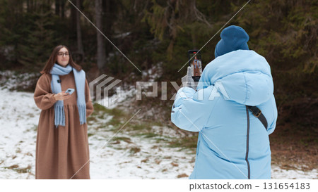 Winter bloggers capture memories in a snowy forest with their smartphones Winter bloggers capture memories in a snowy forest with their smartphones 131654183