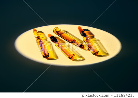 Several ampoules in the spotlight on a beige background. Several ampoules in the spotlight on a beige background. 131654233