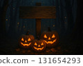 A mysterious woodland path lit by glowing jack-o-lanterns and scattered autumn leaves, evoking the quiet magic of an October evening 131654293