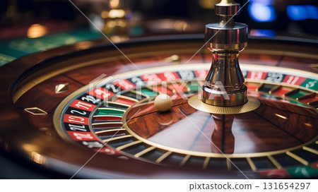 Dynamic close-up shot of a casino roulette wheel, the ball a blur as it spins past black and red numbers, creating a sense of chance, risk and excitement 131654297