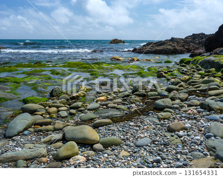 Picturesque view of ocean meeting rugged shoreline. Picturesque view of ocean meeting rugged shoreline. 131654331