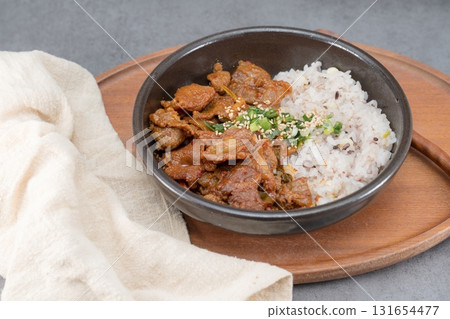 eyukdeopbap, Korean Food Spicy Stir-fried Pork with Rice in Black Bowl  131654477