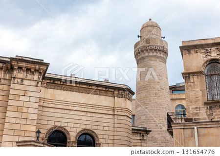 Beige stone building featuring a tall cylindrical minaret, Baku, Azerbaijan Beige stone building featuring a tall cylindrical minaret, Baku, Azerbaijan 131654776