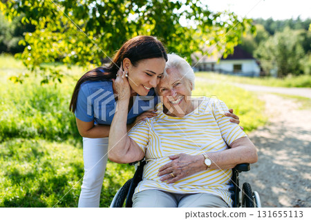 Home nurse taking care of elderly woman in wheelchair. Home nurse taking care of elderly woman in wheelchair. 131655113