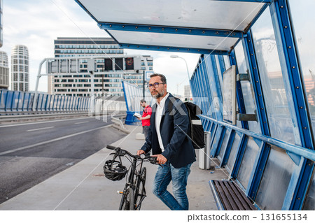 Cyclist waiting for city bus with bicycle. 131655134