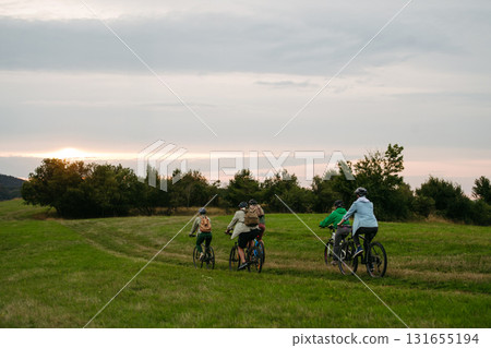 Family biking adventure in nature. Cycling trip during autumn day. 131655194