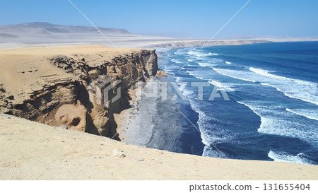 High desert cliffs plunge into deep blue ocean waves High desert cliffs plunge into deep blue ocean waves 131655404