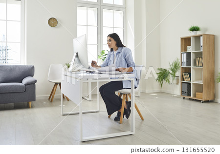 Female accountant, bookkeeper, auditor or secretary working on her computer in the office 131655520