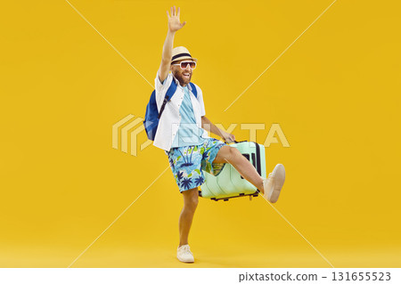 Joyful happy man with suitcase is delighted to go on summer vacation to sea. Joyful happy man with suitcase is delighted to go on summer vacation to sea. 131655523