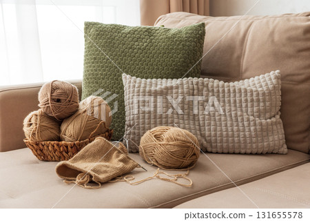 Knitting Basket with Yarn and Velvet Pumpkins in Cozy Autumn Sofa Knitting Basket with Yarn and Velvet Pumpkins in Cozy Autumn Sofa 131655578