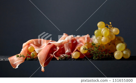 Mediterranean snacks. Grapes with prosciutto and thyme. Mediterranean snacks. Grapes with prosciutto and thyme. 131655800