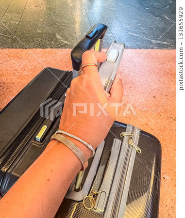 Ready to Travel Hand Holding Suitcase Handle at Airport 131655929