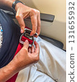 Fastening Airplane Seat Belt 131655932