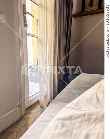 Cozy Morning Light in hotel room with balcony 131655933