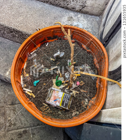 Cigarette Litter in flower Street Pot 131655935
