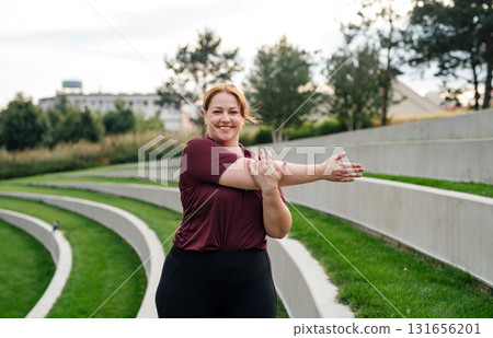 Body positive woman warming up before training. Body positive woman warming up before training. 131656201