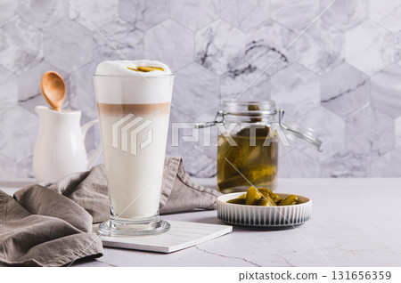 Latte with pickles in a glass and pickles in a bowl on the table Latte with pickles in a glass and pickles in a bowl on the table 131656359
