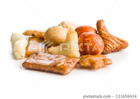 Salted snack. Coated peanuts and mini crackers isolated on white background. 131656914