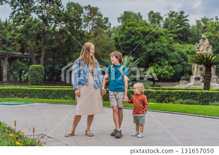 Mother with her two sons standing near Chapultepec Castle in Mexico City, enjoying sightseeing and family travel. Cultural heritage and tourism concept Mother with her two sons standing near Chapultepec Castle in Mexico City, enjoying sightseeing and family travel. Cultural heritage and tourism concept 131657050