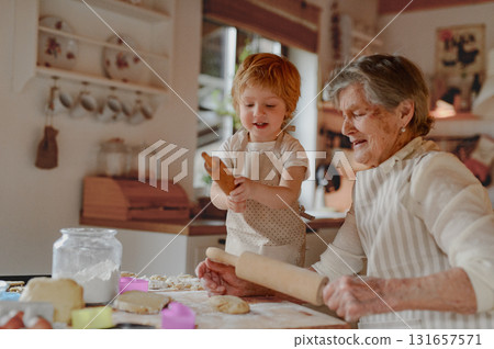 Christmas baking tradition with grandma and little kid. 131657571