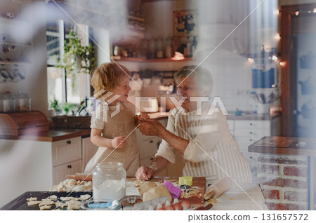 Christmas baking tradition with grandma and little kid. Christmas baking tradition with grandma and little kid. 131657572