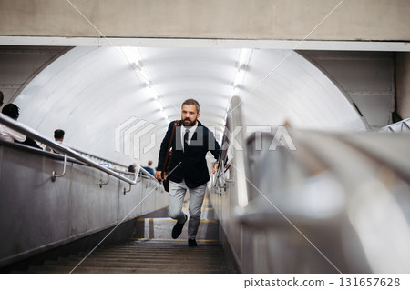 Man walking out of subway station. 131657628