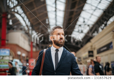 Businessman with a bag waiting for the train in subway. 131657629