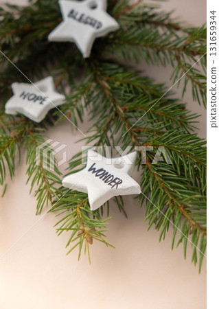 Christmas star with word WONDER White air dry clay for making decor to Christmas tree holiday. Creating hobby recreation activity that involves fingers. DIY crafting Christmas star with word WONDER White air dry clay for making decor to Christmas tree holiday. Creating hobby recreation activity that involves fingers. DIY crafting 131659344