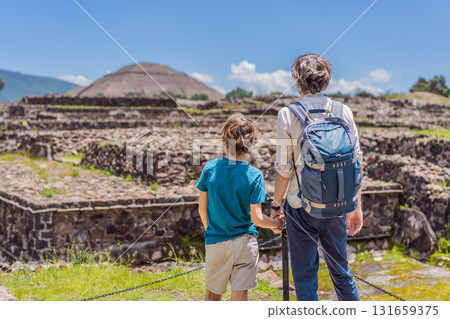 Father and his son as tourists in front of the pyramids of Teotihuacan, Mexico, enjoying sightseeing, travel, and cultural heritage together 131659375