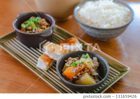 日式早餐套餐,包括納豆、味噌湯、烤年糕和肉薯燉菜 日式早餐套餐,包括納豆、味噌湯、烤年糕和肉薯燉菜 131659426