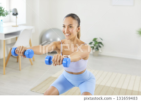 Sporty fit slim beautiful woman in sportswear, girl doing dumbbell squat morning exercise 131659483