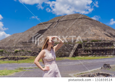 Female tourist standing in front of Teotihuacan pyramids in Mexico, enjoying sightseeing, adventure, and cultural heritage. Travel, tourism, and exploration concept Female tourist standing in front of Teotihuacan pyramids in Mexico, enjoying sightseeing, adventure, and cultural heritage. Travel, tourism, and exploration concept 131659514