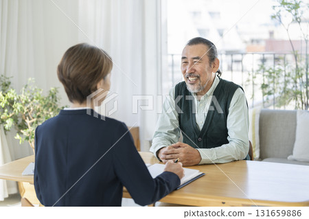 A senior man talking to a businesswoman A senior man talking to a businesswoman 131659886